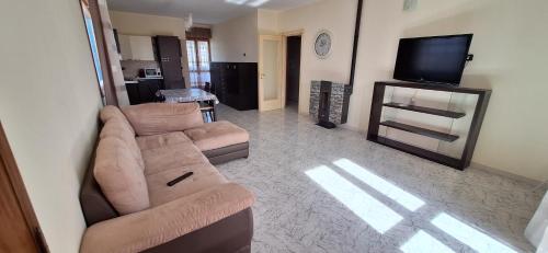 a living room with a couch and a flat screen tv at Mara casa vacanza in Maracalagonis
