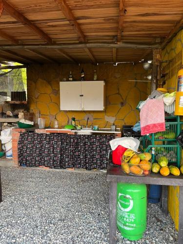 a kitchen with a counter with fruit on it at CABAÑAS EL PARAISO PESCADERITO in Curití