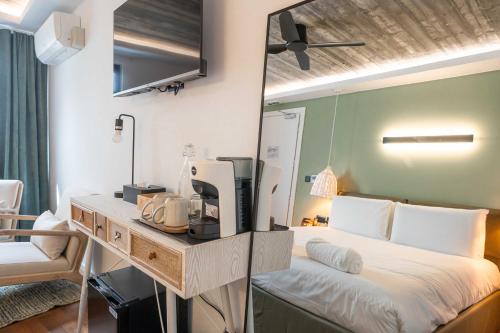 a bedroom with a bed with a desk and a mirror at The Bear and Ween in St Julian's