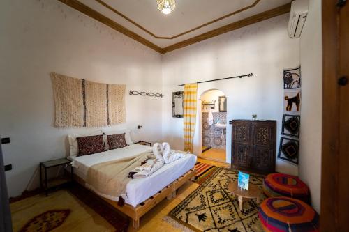 Ein Bett oder Betten in einem Zimmer der Unterkunft L'oasis Du Bonheur