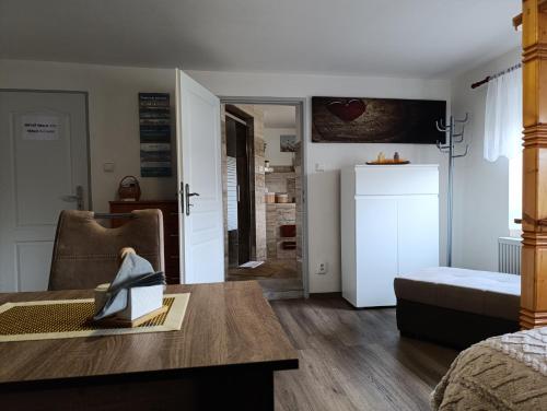 a living room with a table and a refrigerator at U Bocmana s výhledem na zámek a Labe in Děčín