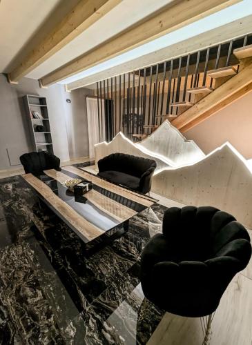 a living room with two couches and a table at Titi House Borsa in Borsa