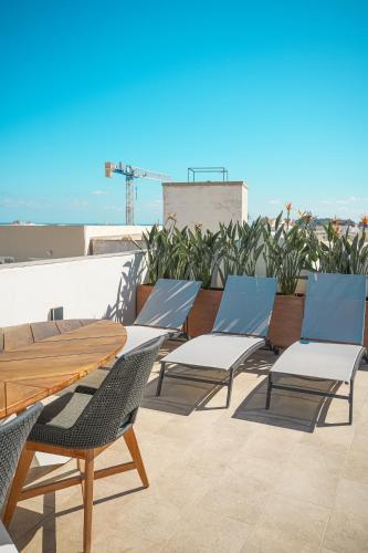 a group of chairs and tables on a roof at The Bear and Ween in St Julian's