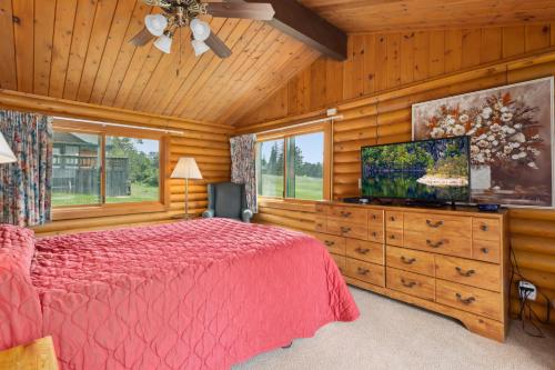 a bedroom with a bed and a flat screen tv at The Lodges at Breezy Point in Breezy Point