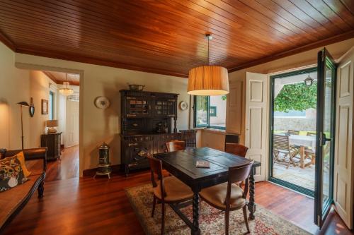 a dining room with a wooden ceiling and a table at Feel Discovery Casa do Rio Douro Valley in Riba Douro
