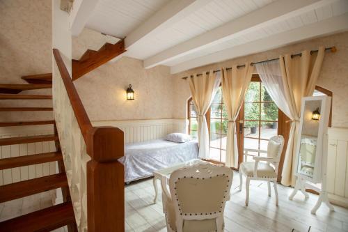 a bedroom with a bed and a staircase at Hotel Casablanca Spa & Wine in Casablanca