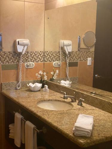 a bathroom counter with a sink and a mirror at Hotel Boutique Casona del Cafetal and Lakeside Restaurant in Cachí