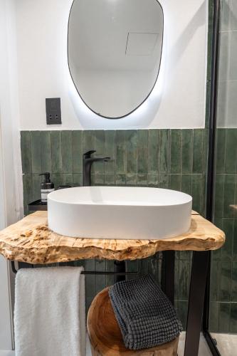 a bathroom with a white sink and a mirror at The Bear and Ween in St Julian's