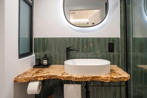 a bathroom with a white sink and a mirror at The Bear and Ween in St Julian's