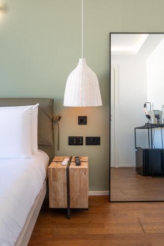 a bedroom with a bed with a table and a mirror at The Bear and Ween in St Julian's