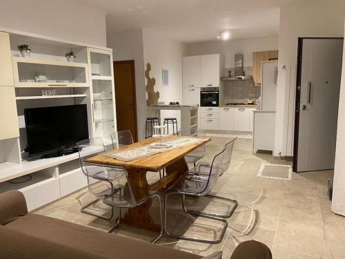 a kitchen with a wooden table and chairs in it at Casa LorEnzo in Manziana
