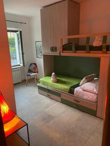 a bedroom with two bunk beds and a chair at Casa LorEnzo in Manziana