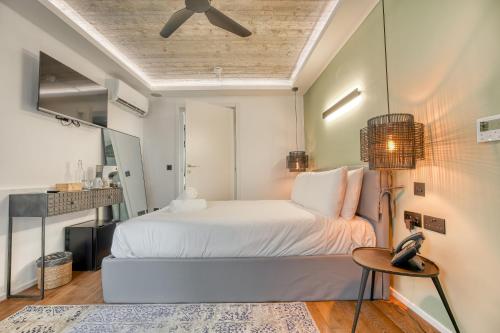 a bedroom with a white bed and a table at The Bear and Ween in St Julian's