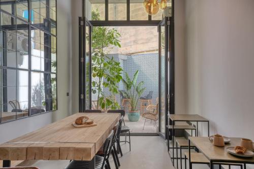 a dining room with tables and chairs and a patio at The Bear and Ween in St Julian's