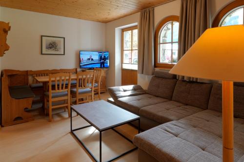 a living room with a couch and a table at Landhaus Stiegler in Untertauern