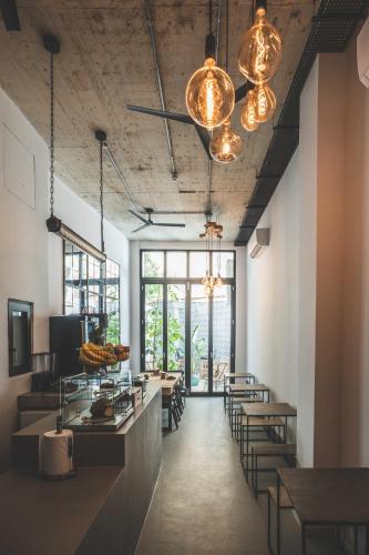 a dining room with tables and chairs and lights at The Bear and Ween in St Julian's