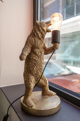 a statue of a bear holding a lamp at The Bear and Ween in St Julian's