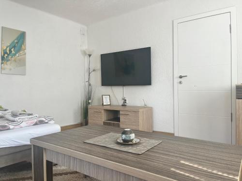 a living room with a tv and a coffee table at Apartment Irma in Sarajevo