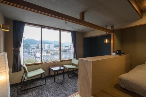 a hotel room with a bed and a window at Irifuneso in Ureshino