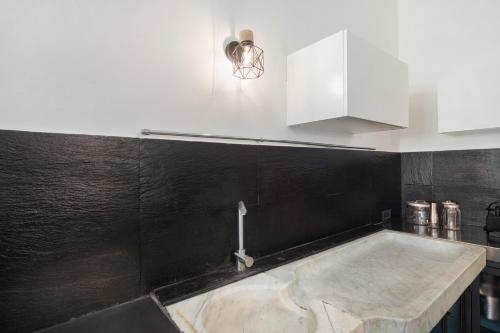 a kitchen with a sink and a faucet at Da Linda in Cisano sul Neva