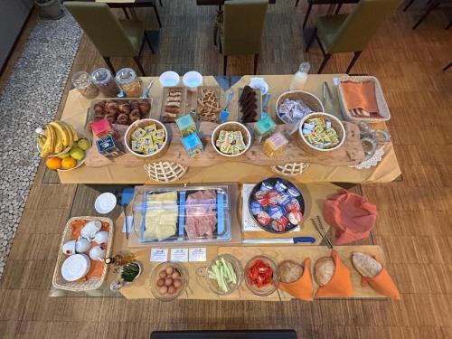 a table filled with different types of food at Cascina Scova Resort in Pavia