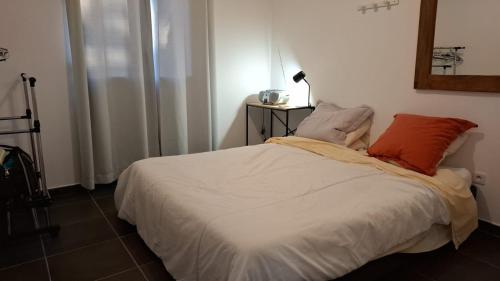 a bed with two pillows on it in a room at CapNature in Saint-André