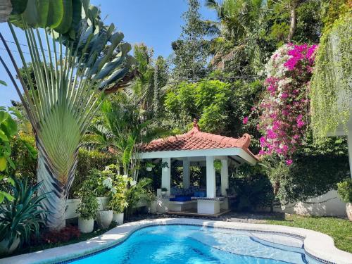 a house with a swimming pool and a gazebo at SUNKISS VILLA by Yogya Tropicana in Yogyakarta