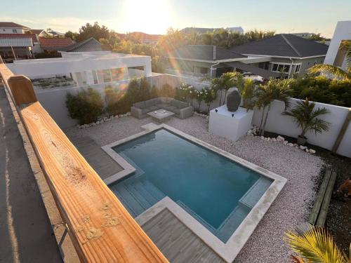 a swimming pool in the backyard of a house at Villa Perla di Solo, 6 persoons, met privézwembad en groot dakterras met zeezicht! in Grote Berg