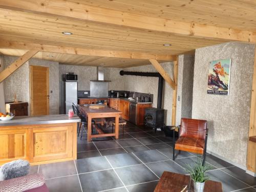a large kitchen with wooden cabinets and a wooden ceiling at Chez Papy - Grand Appart Entirely renovated Ventelon La Grave La Meije in La Grave