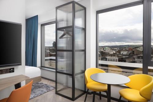 a room with a table and chairs and a window at Residence Inn by Marriott Cork in Cork