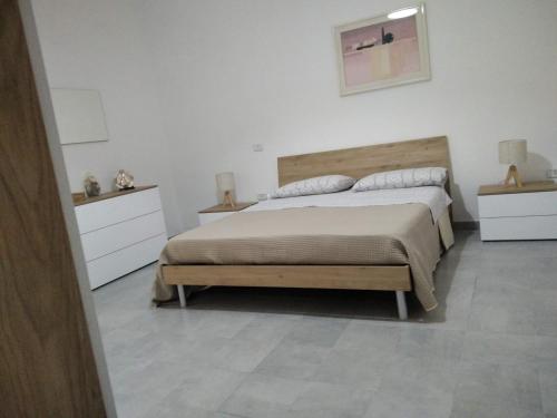 a bedroom with a large bed and two night stands at Casa di Matilde in Lizzanello