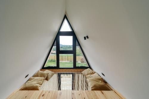 a room with a large window in a house at SunMoon Kosmaj kućice i prostor za događaje in Sopot