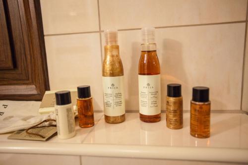 four bottles of essential oils sitting on a shelf at Filokalia Hotel in Ioannina