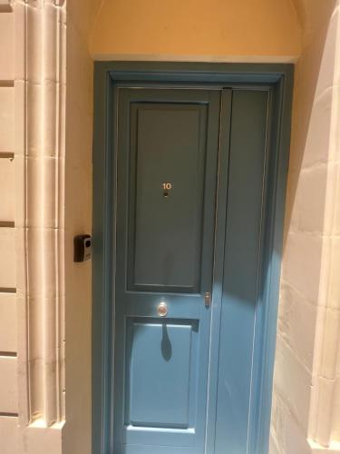 a blue door in the corner of a building at Duplex Modern House , Centrally located in Cospicua