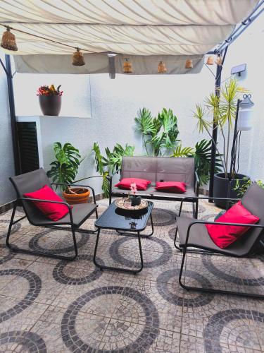 a group of chairs and tables in a room with plants at Old Town House Madeira in Funchal