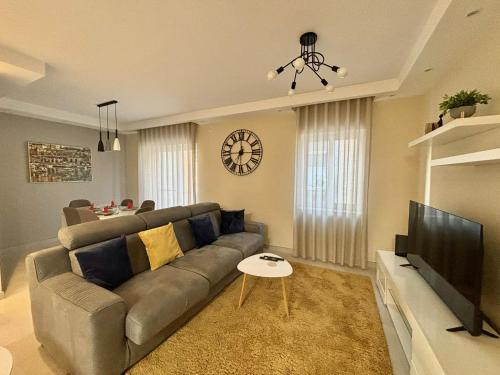 a living room with a couch and a television at Stylish 2 Bedrooms apartment in Gzira in Il-Gżira