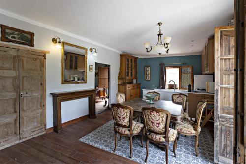 a living room with a table and chairs and a kitchen at Casa Rural Gite El Tossal in Collfred