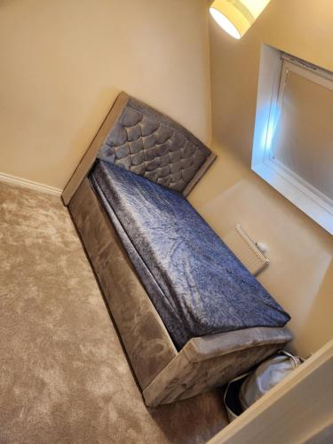 a small bed in the corner of a room at 69 swan lane in Coventry