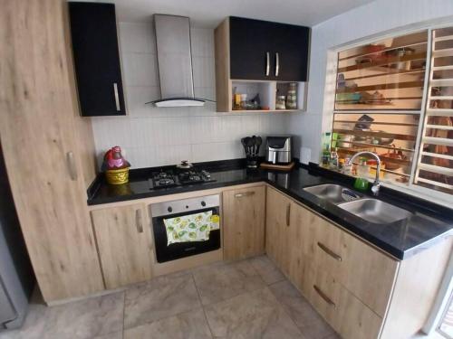 a kitchen with a sink and a stove at Espectacular Casa en Barbosa Santander in Barbosa