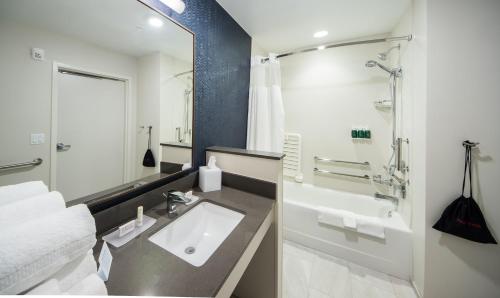 a bathroom with a sink and a shower and a tub at Fairfield Inn & Suites by Marriott Melbourne Viera Town Center in Melbourne