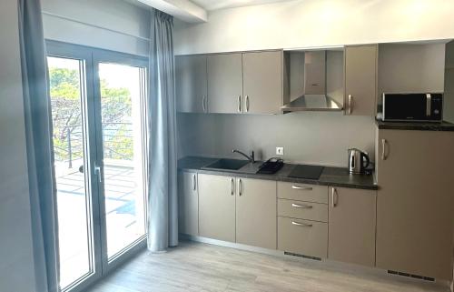 a kitchen with a sink and a counter top at ADRIA MIRIS apartments in Drasnice