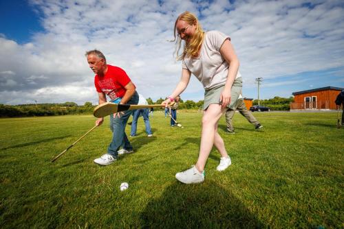 a group of people playing a game of golf at Stoneyford Luxurious Cabins in Stonyford
