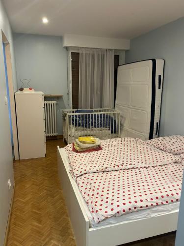a bedroom with a white bed in a room at Your home Chaville in Chaville