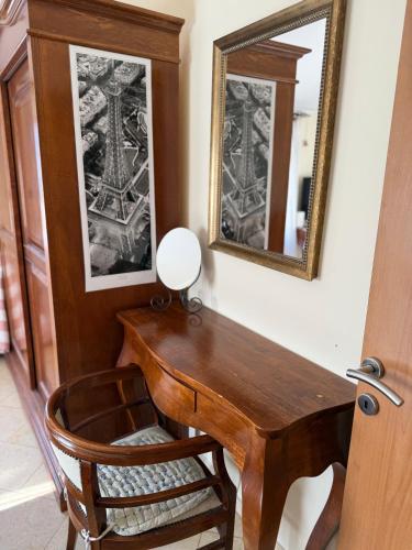 a wooden desk in a room with a mirror at Apartment LANA on the seashore in Kamenarovići