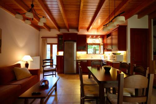 a kitchen and living room with a couch and a table at 7hills Waterfall Lodge by Ski Alure in Eptalofos