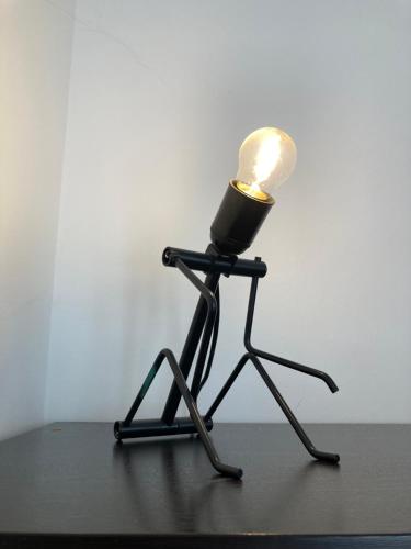 a lamp on a tripod with a light on it at Casa Finestre Bianche in Canelli