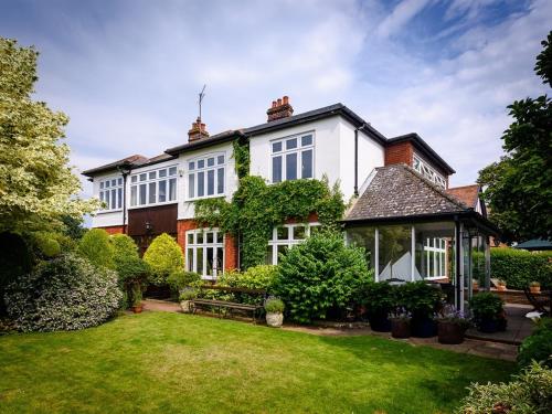 a large white house with a yard at Barnard House in Great Yarmouth