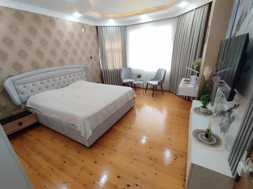 a bedroom with a bed and a table and chairs at Guest House Savalan in Baku