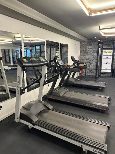 a gym with three treadles in a room at Hotel Fazenda Vilarejo All Inclusive in Conservatória
