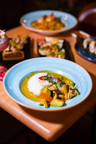 a table with a plate of food on a table at Radisson Blu Hotel, Dubai Media City in Dubai